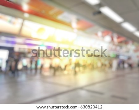 Abstract blurred image of people in sky train station in night time, city lifestyle concept