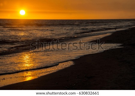 Golden sunset on the ocean waves of Sanibel Island.