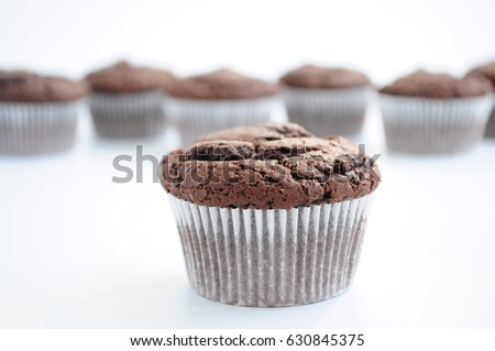 Chocolate muffins on white background. Picture for a menu or a confectionery catalog.