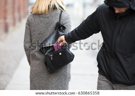 Close-up Of A Person Stealing Purse From Handbag Royalty-Free Stock Photo #630865358