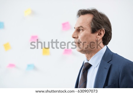 side view of serious stylish businessman in suit