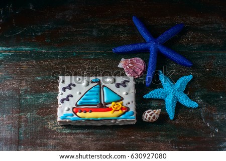 Homemade homemade gingerbread cookie in the shape of a boat on the dark dark wooden background. Selective focus.