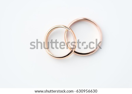 two golden wedding rings isolated on white, wedding rings background concept Royalty-Free Stock Photo #630956630