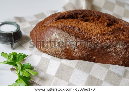 Loaf of rye bread on linen napkin.Selective focus.