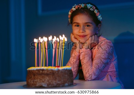 Portrait of little pretty girl with birthday cake