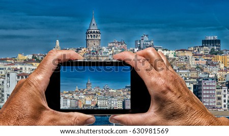 Man and woman hand capturing Beyoglu skyline skyline with smartphone