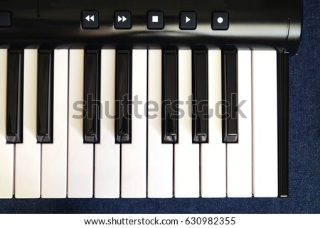 Piano keyboard with white and black keys isolated on white background front view vertical  photo close up