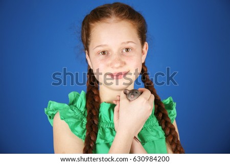 Cute girl with funny rat on color background
