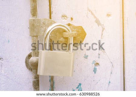 Metal padlock on wooden door, closeup. Nobody