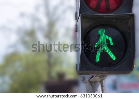 A traffic light with a green little man. Safety on the roads. Life insurance.