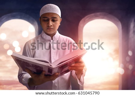 Muslim man reading koran in mosque Royalty-Free Stock Photo #631045790