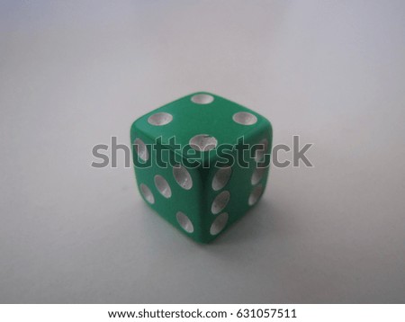 Green dice with white background.
