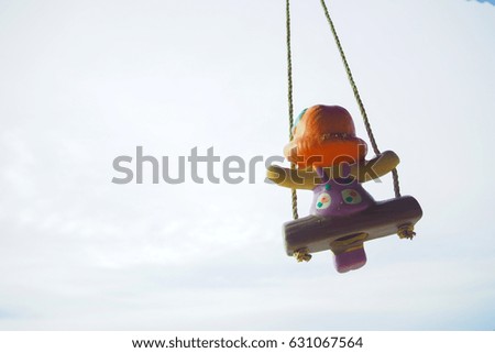Little girl doll with white sky background