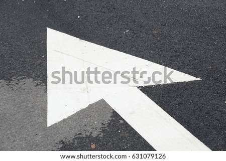 Asphalt road. Arrow sign on asphalt