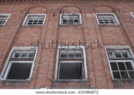Windows of broken vandalism on a brick wall. Abandoned building. Photo for your design.