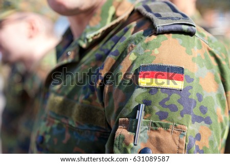 german flag on german army uniform Royalty-Free Stock Photo #631089587