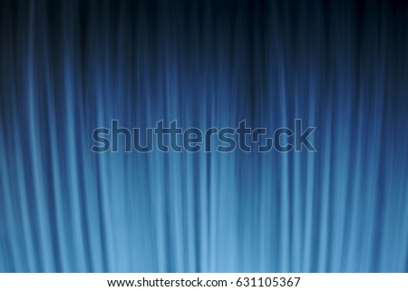 Abstract vertical stripes of waterfall long exposure of blue and white lines steaming down in soft curtain