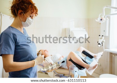 Red hair female doctor gynecologist performing an examination Royalty-Free Stock Photo #631110113