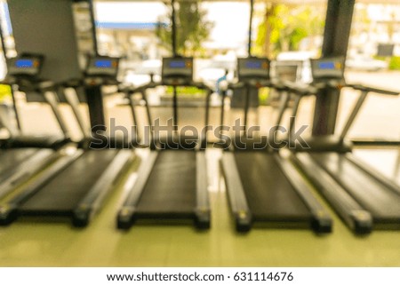 Abstract blurred background of exercise equipments in modern fitness gym