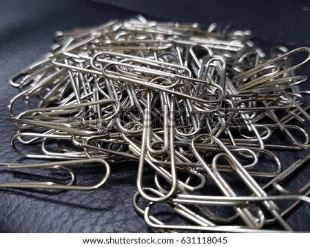 Pile of paperclips in office.