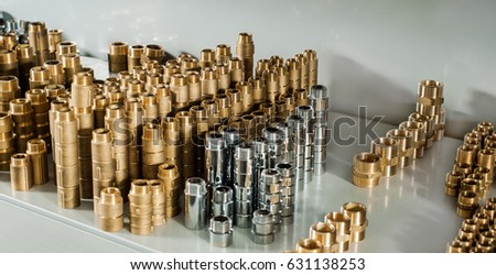 Plumbing equipment chrome and brass valves tees elbows Royalty-Free Stock Photo #631138253
