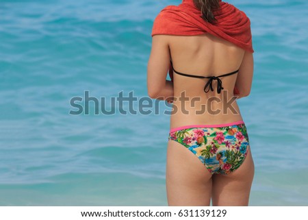 Caucasian Woman Tourist wear Bikini Swimsuit Relax on The Sea Beach with Sea Background. Set as Copy Space for Text.