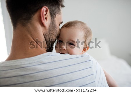 Father holding his baby girl at home Royalty-Free Stock Photo #631172234