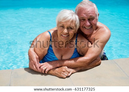 Portrait of happy senior couple embracing each other in pool