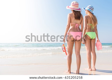 Beach vacation snorkel girl snorkeling with mask and fins. Bikini women relaxing on summer tropical getaway doing snorkeling activity with snorkel tuba and flippers sun tanning. Suntan skin body care.