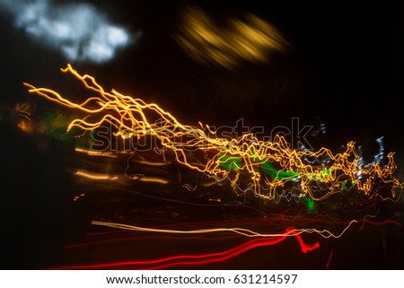 Moving along the night road. Night traffic. City life. Blurred lights for abstract color background.