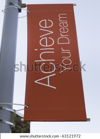 Motivational banner on campus of community college: Achieve Your Dream