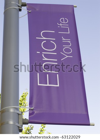 Motivational banner on campus of community college: Enrich Your Life