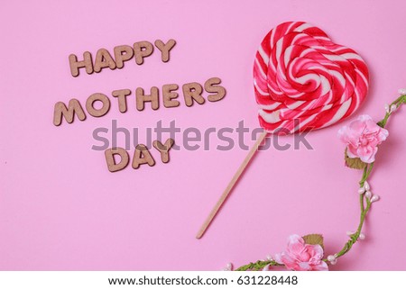 mother's day concept. HAPPY MOTHER DAY alphabet with colorful heart and red bucket on pink background