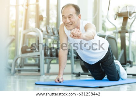 Asian senior man push up at the gym. copy space.