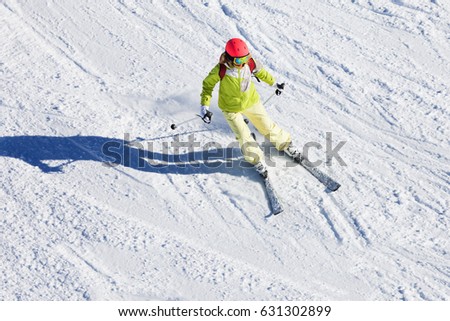 Female skier hitting the slopes at sunny day