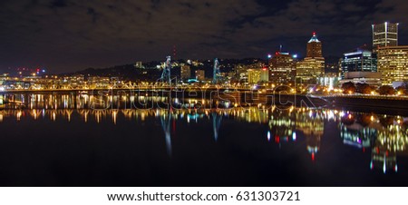 Panoramic skyline view with the steel bridge of Portland, Oregon at night
