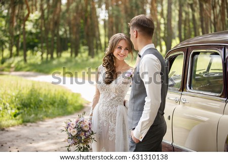 Wedding couple in rustic style on just married car background. Happy bride and groom.