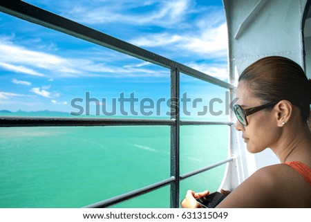 Picture of attractive beautiful Asian woman is traveling by boat in the middle of the sea.