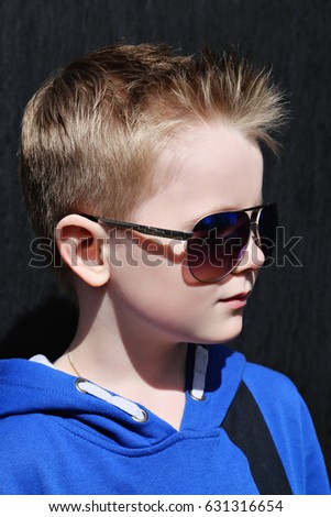 Beauty boy with trendy hairstyle and fashionable sunglasses