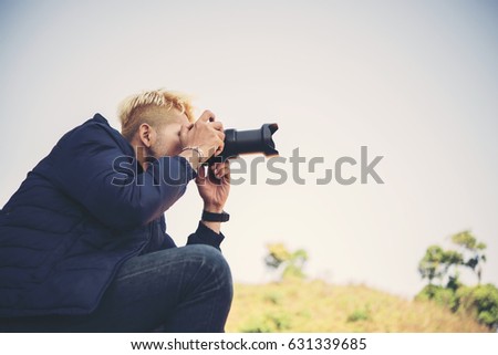 Men hiking with camera in nature.