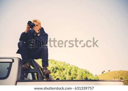 Men hiking with camera in nature.