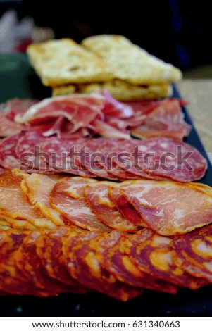 Rustic plate with various type of salami , bacon and bread 