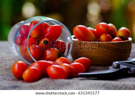 Red tomatoes in glass placed on a hemp sack.