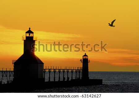 St. Joseph North Pier Lights in St. Joseph, Michigan at sunset. Royalty-Free Stock Photo #63142627