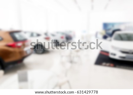 Blur background of car dealership showroom in white background. For car, automotive, dealer, showroom, shopping concepts.