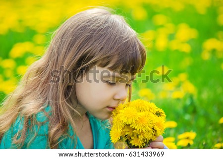 Girl, child, flowers in the spring plays. Selective focus.