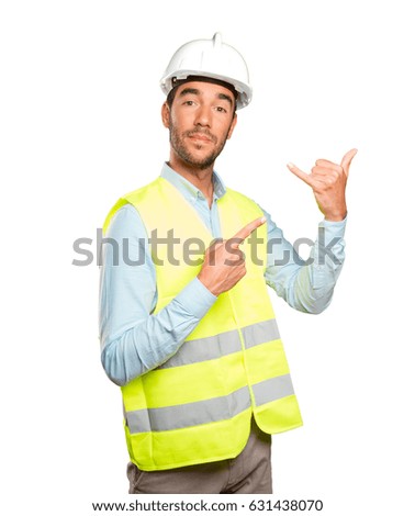 Happy engineer with call gesture against white background