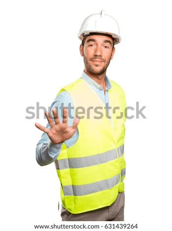 Confident engineer with keep calm gesture against white background