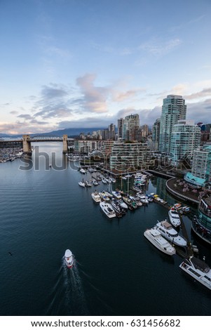 Aerial view on the Downtown Vancouver Buildings during a cloudy morning sunrise. Picture taken in False Creek, British Columbia, Canada.