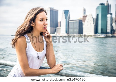 Beautiful woman portrait with Manhattan skyline in the background